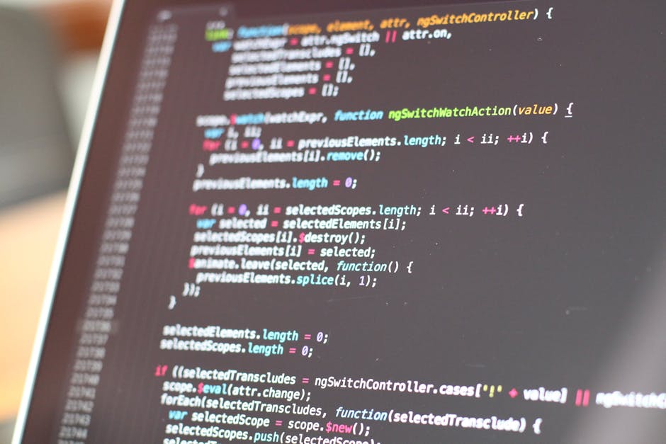 A close-up view of a computer screen displaying lines of colorful code in an IDE, with syntax highlighting in shades of pink, green, blue, and white on a dark background. The code includes functions, 