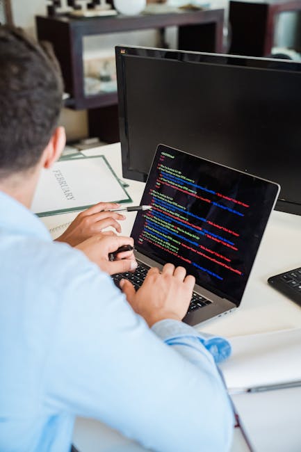 A close-up view of a computer screen displaying HTML code with colorful syntax highlighting, including tags, attributes, and textual elements, indicative of web development or coding work. The screen 